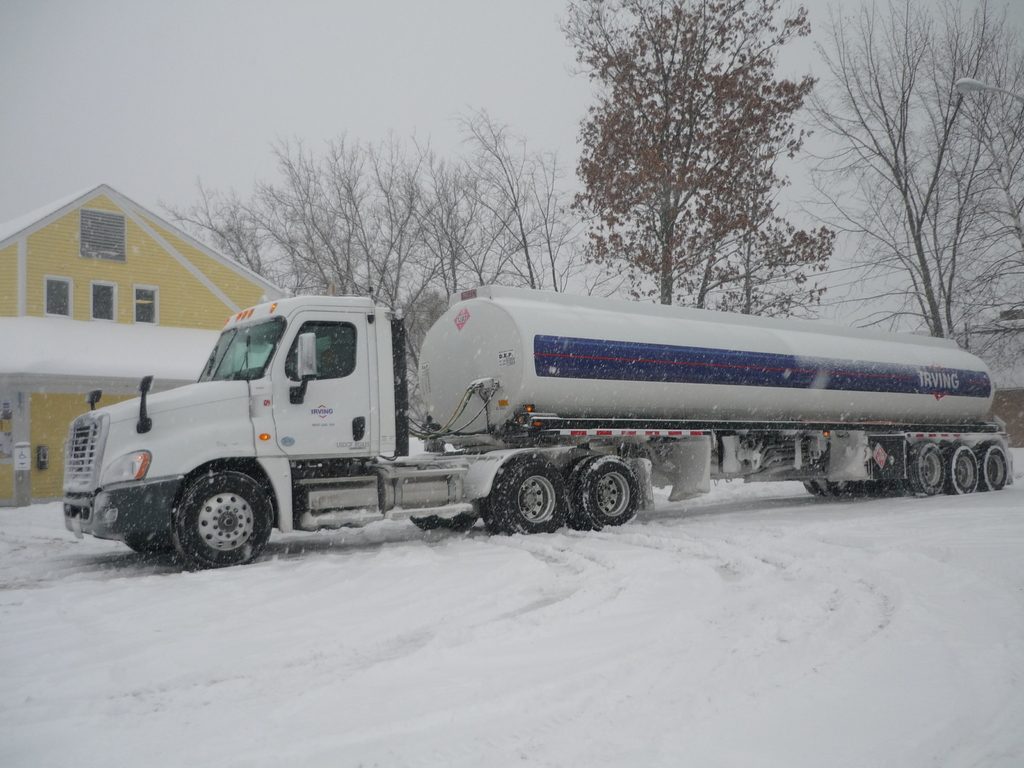 Semi truck with tanker trailer on a snowy road